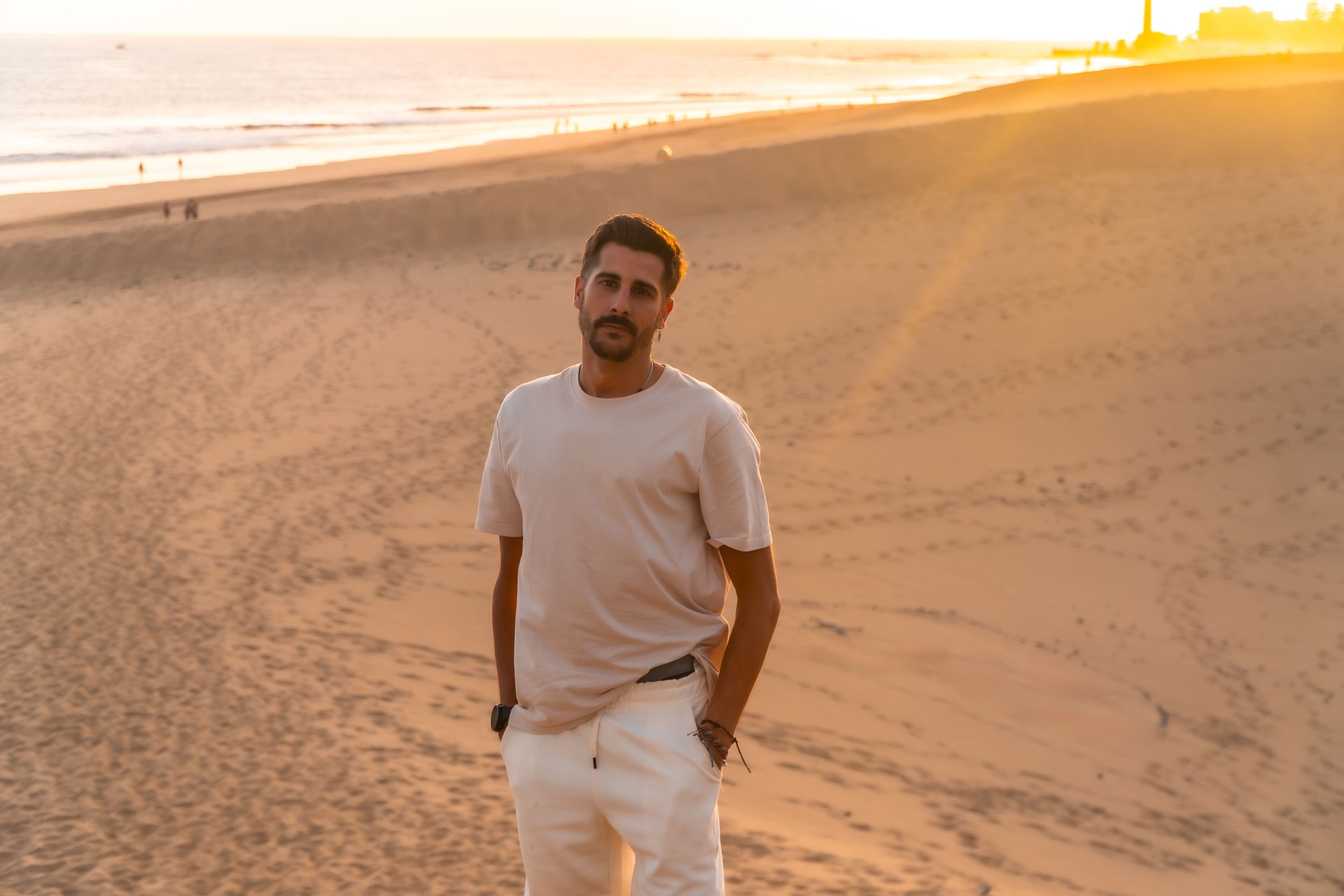 Tourist exploring maspalomas dunes at sunset in gran canaria