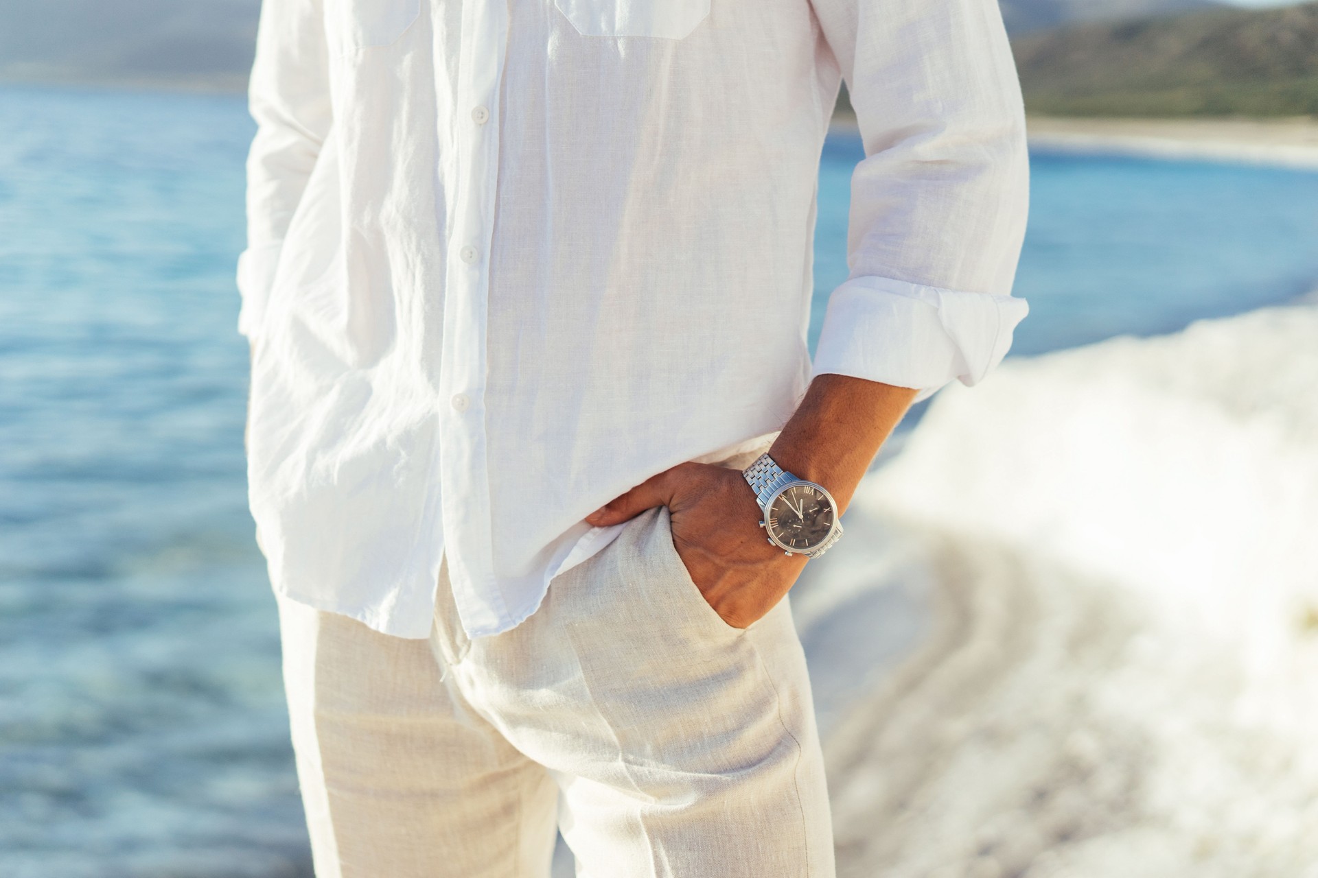 Well dressed man putting his wrist watch